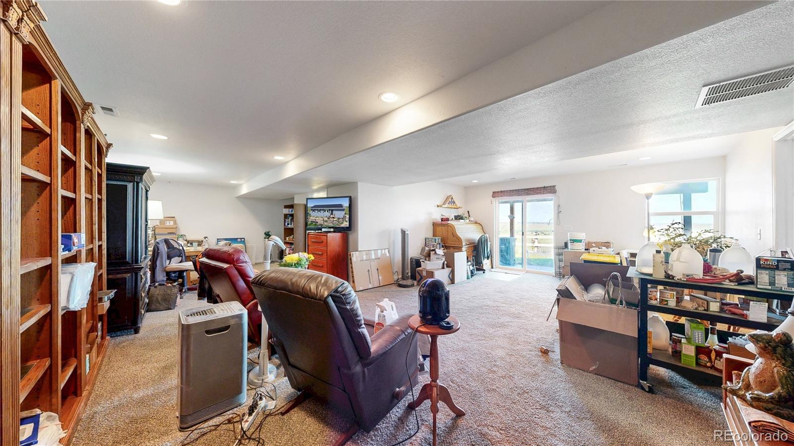 40291 Gold Nugget Road Deer Trail, CO 80105 - Photo 28 of 47 a living room with furniture and a flat screen tv