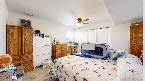 a bedroom with a bed and wooden cabinets