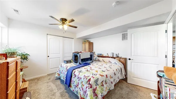 a bedroom with bed and a chandelier