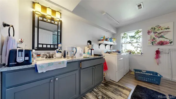 a room with sink cabinets and window