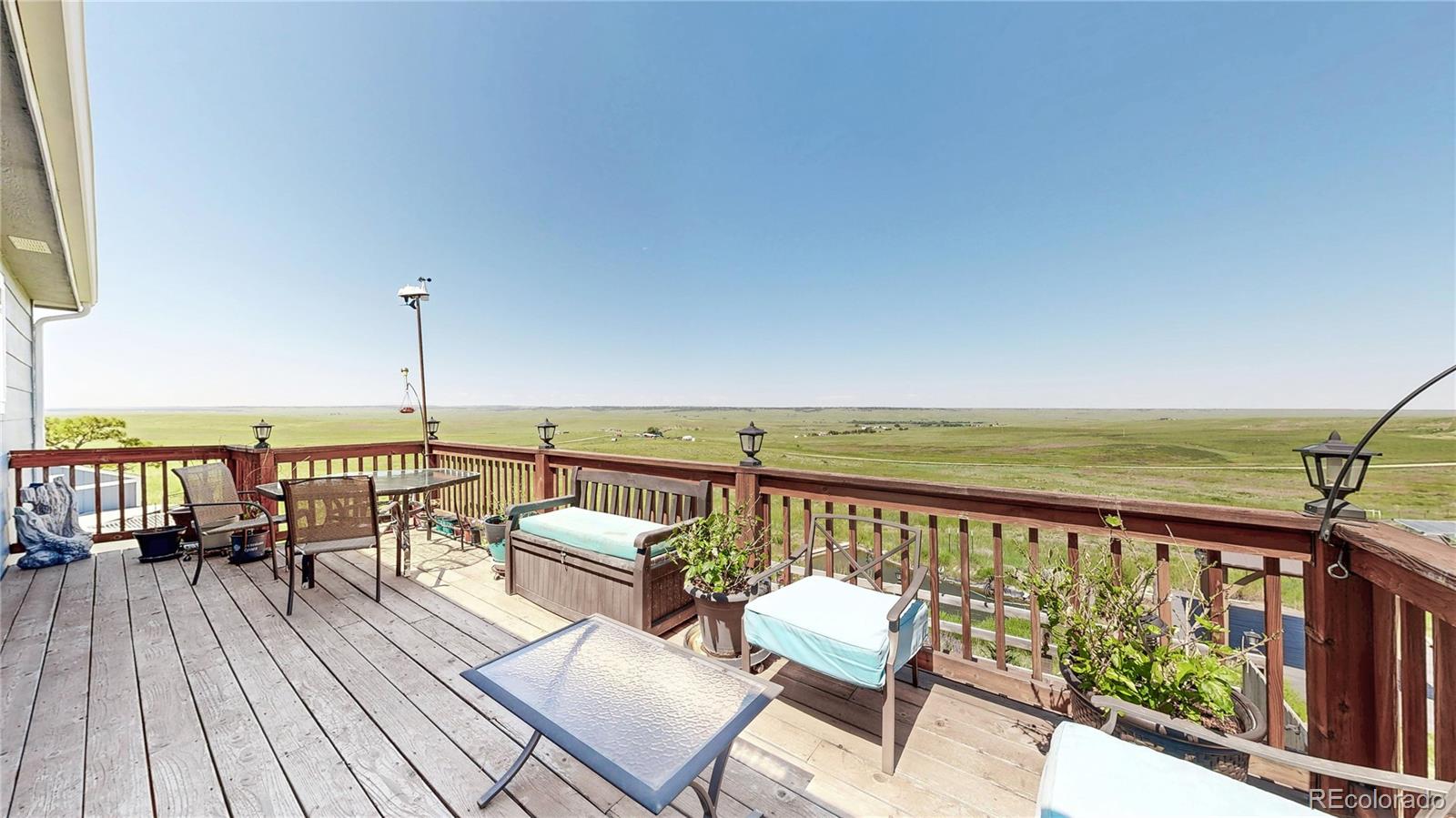 40291 Gold Nugget Road Deer Trail, CO 80105 - Photo 37 of 47 an outdoor view from a balcony with seating space