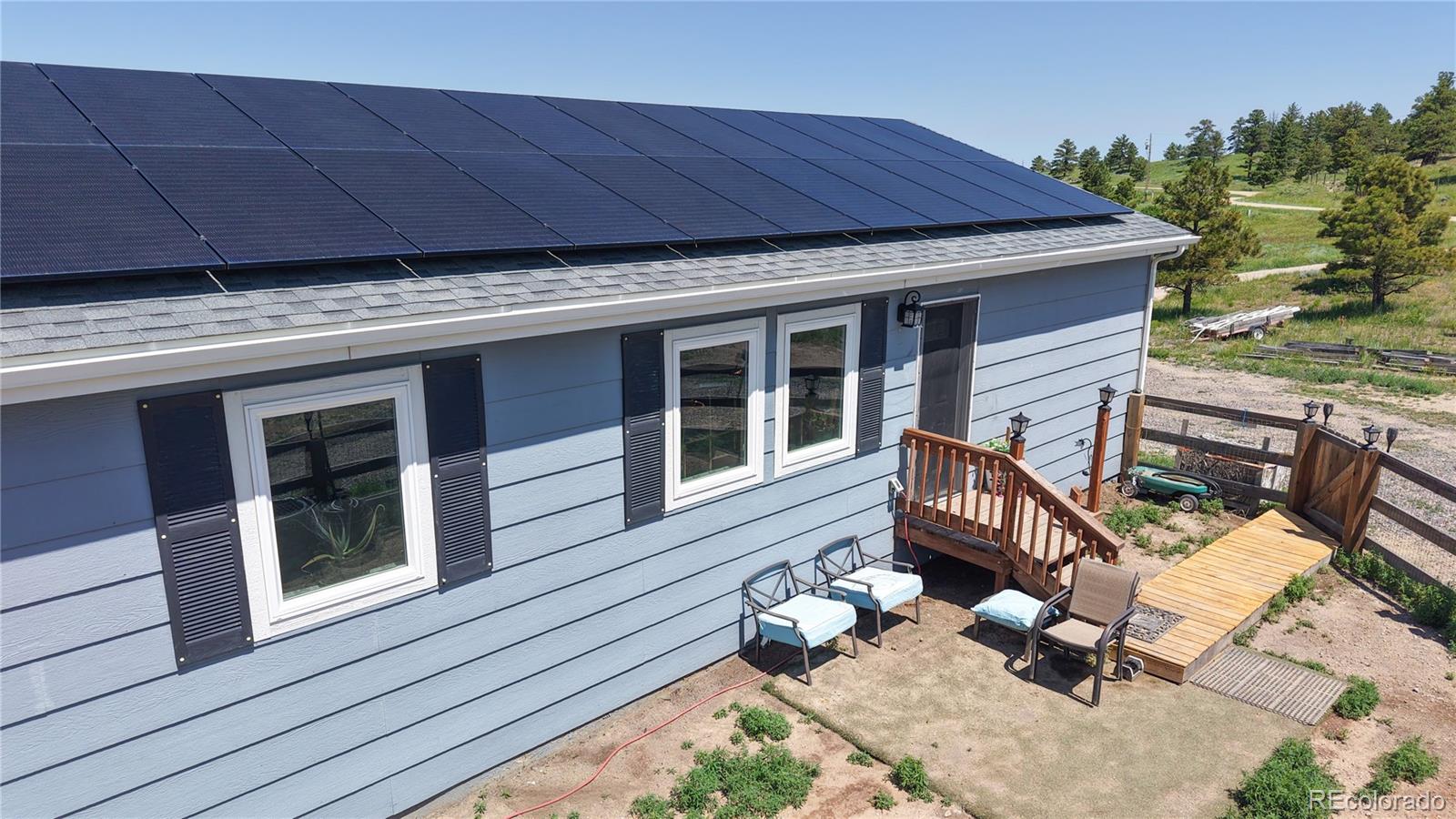 40291 Gold Nugget Road Deer Trail, CO 80105 - Photo 8 of 47 a view of a deck with wooden floor and seating space