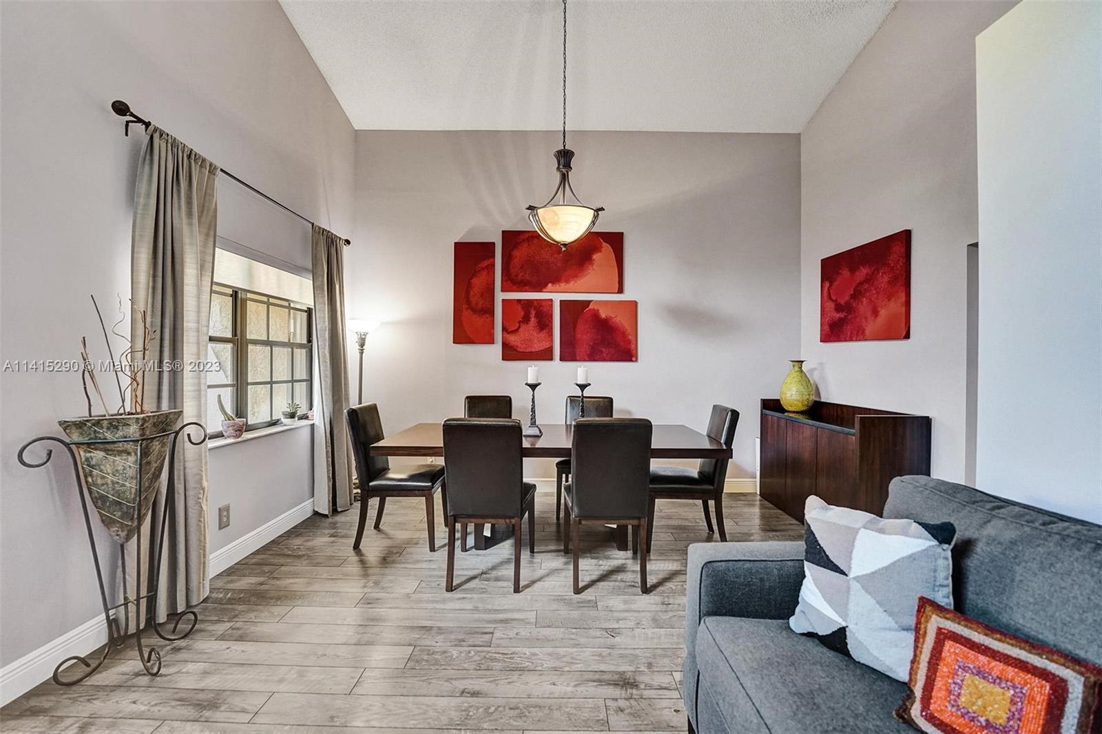 9641 Ridgeside Court Davie, FL 33328 - Photo 13 of 78 a dining room with furniture a chandelier and wooden floor