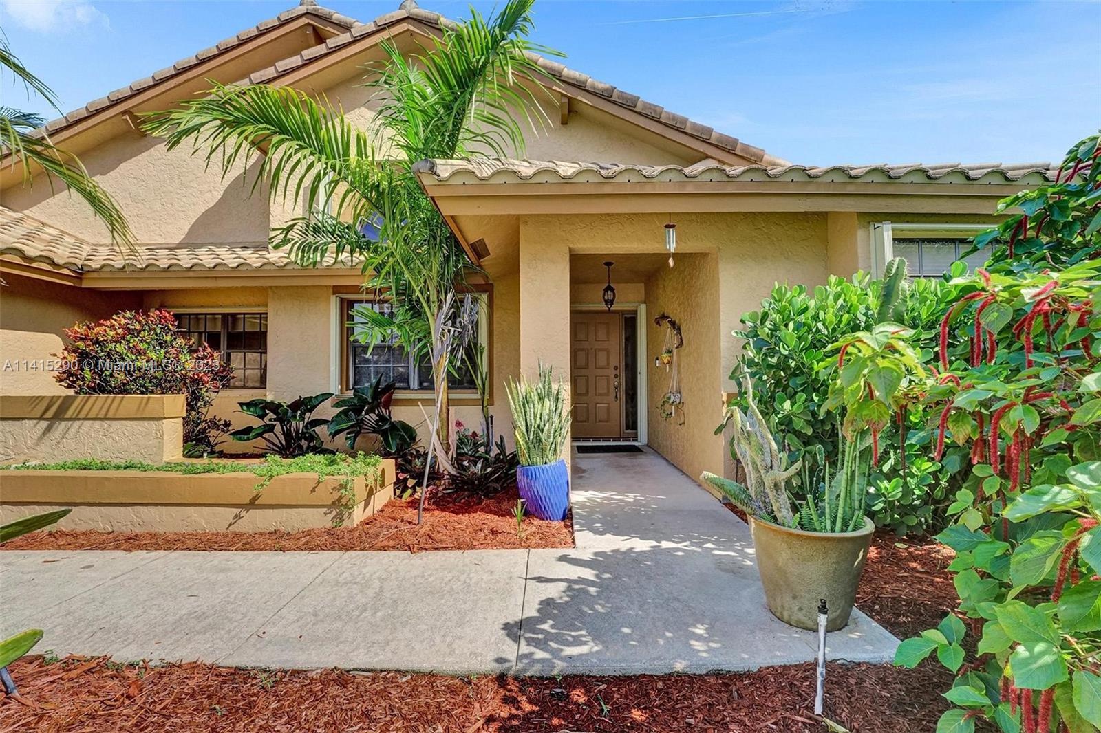 9641 Ridgeside Court Davie, FL 33328 - Photo 2 of 78 a view of a house with potted plants