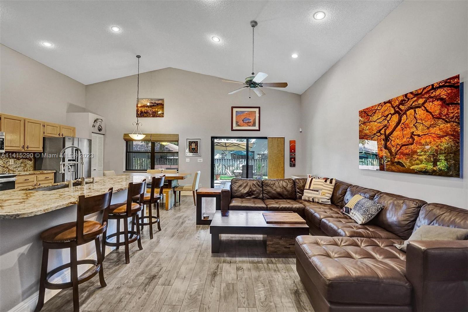 9641 Ridgeside Court Davie, FL 33328 - Photo 21 of 78 a living room with furniture kitchen view and a wooden floor