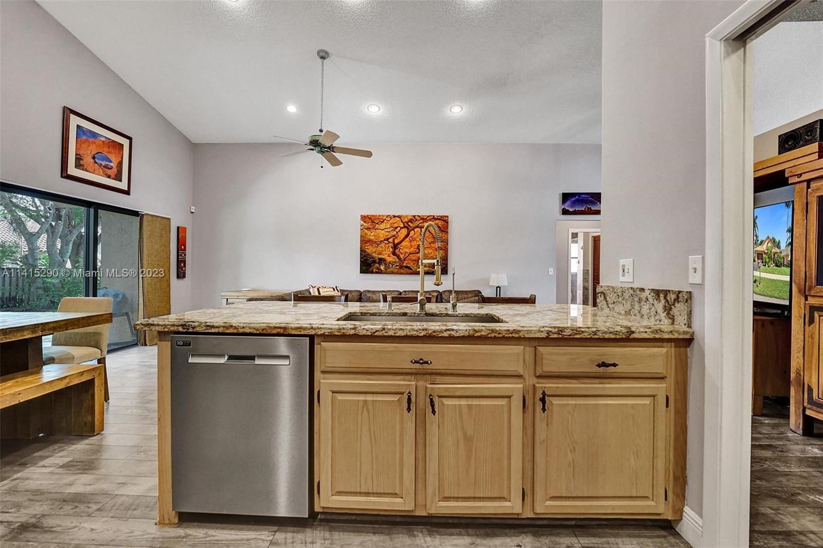 9641 Ridgeside Court Davie, FL 33328 - Photo 28 of 78 a kitchen with cabinets and chairs