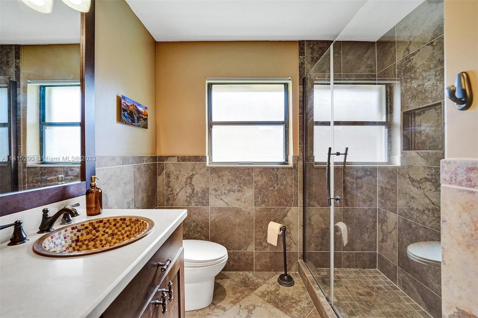 9641 Ridgeside Court Davie, FL 33328 - Photo 39 of 78 a bathroom with a sink toilet and shower