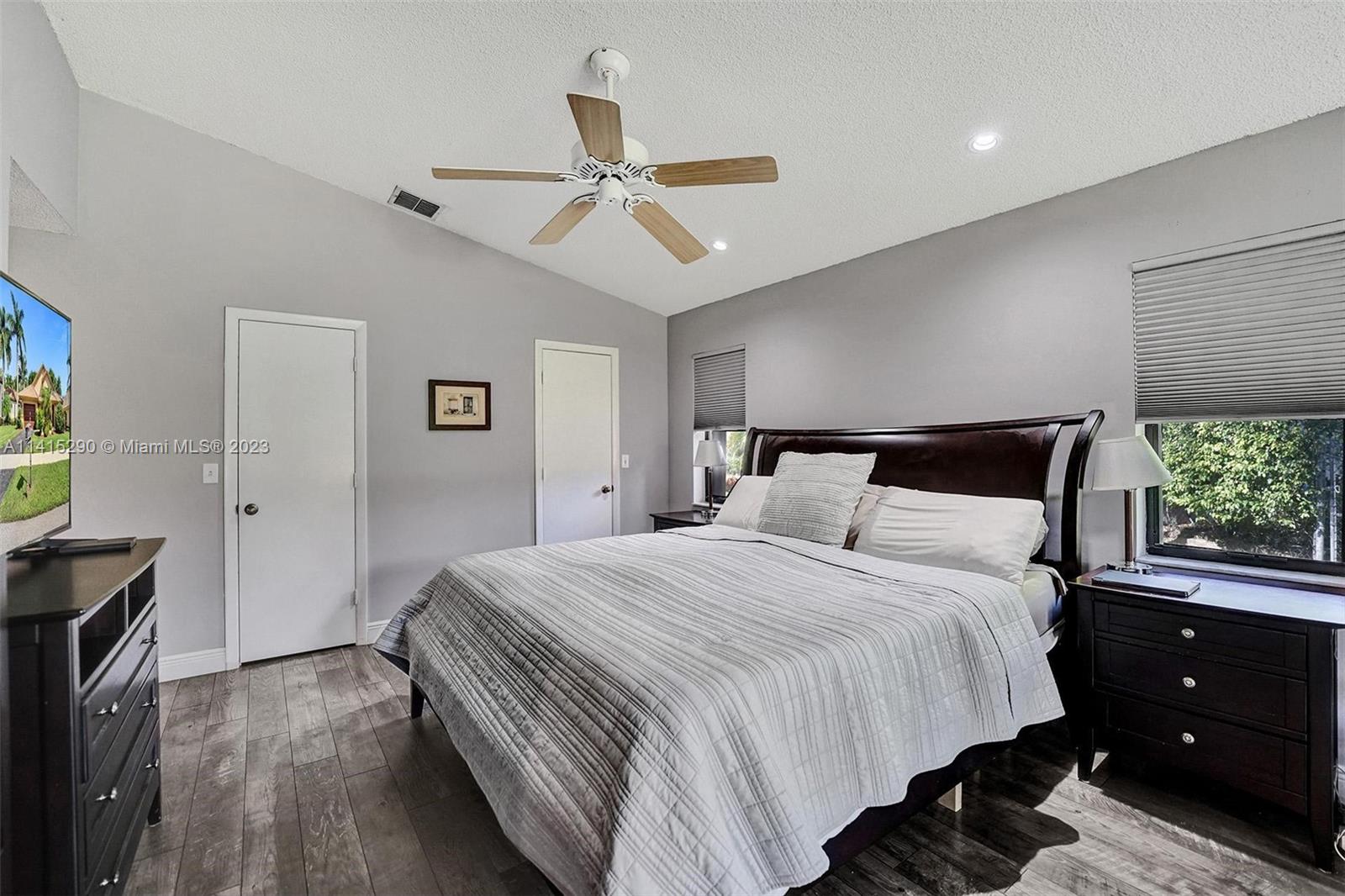 9641 Ridgeside Court Davie, FL 33328 - Photo 43 of 78 a bedroom with a bed and a chandelier