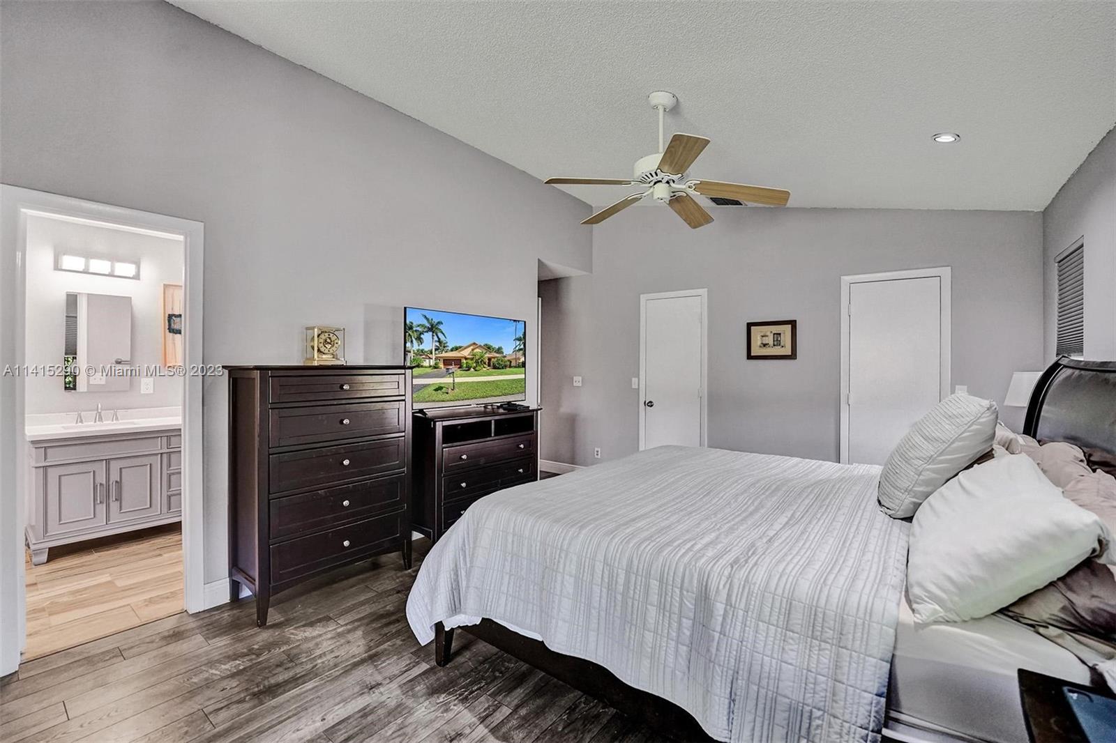 9641 Ridgeside Court Davie, FL 33328 - Photo 44 of 78 a bedroom with a bed and a chandelier