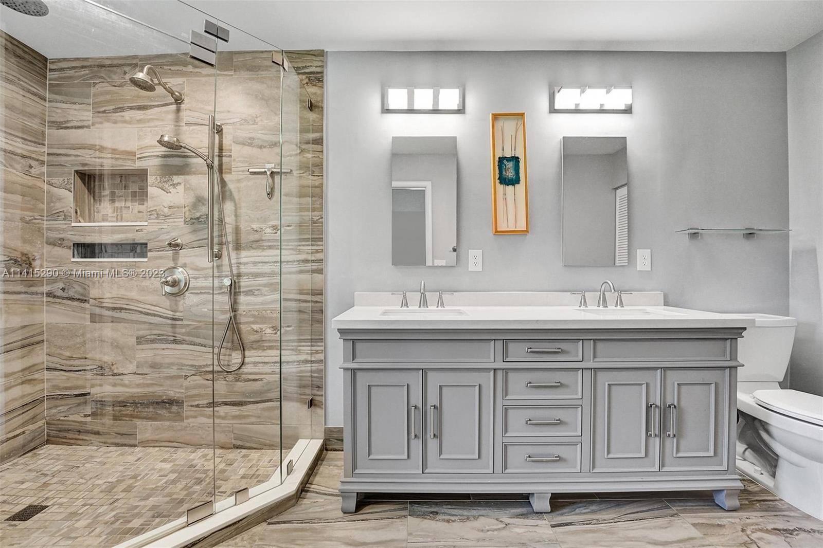 9641 Ridgeside Court Davie, FL 33328 - Photo 46 of 78 a bathroom with a granite countertop sink a mirror a shower and a bathtub