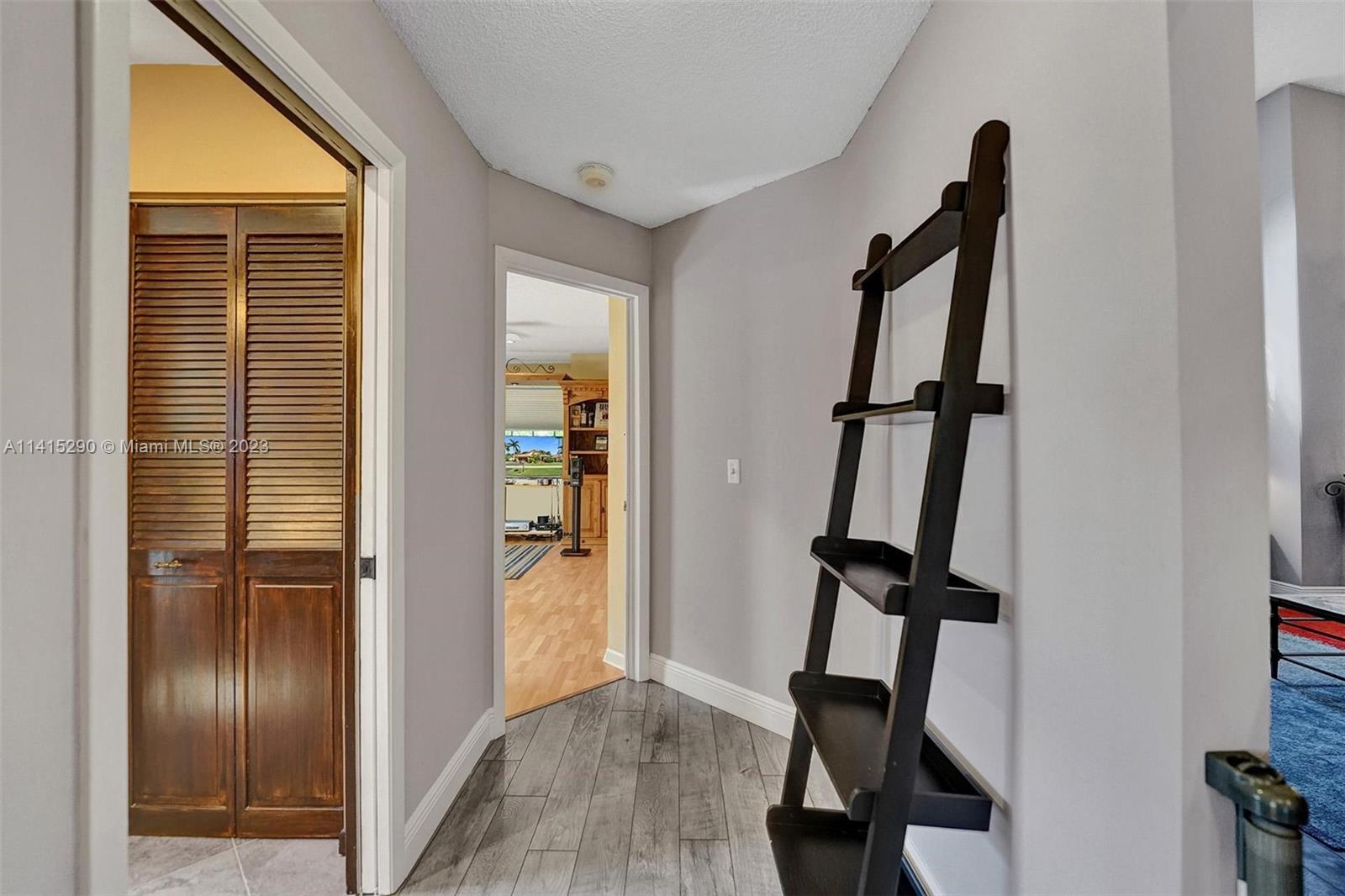 9641 Ridgeside Court Davie, FL 33328 - Photo 52 of 78 a view of hallway with furniture and a window