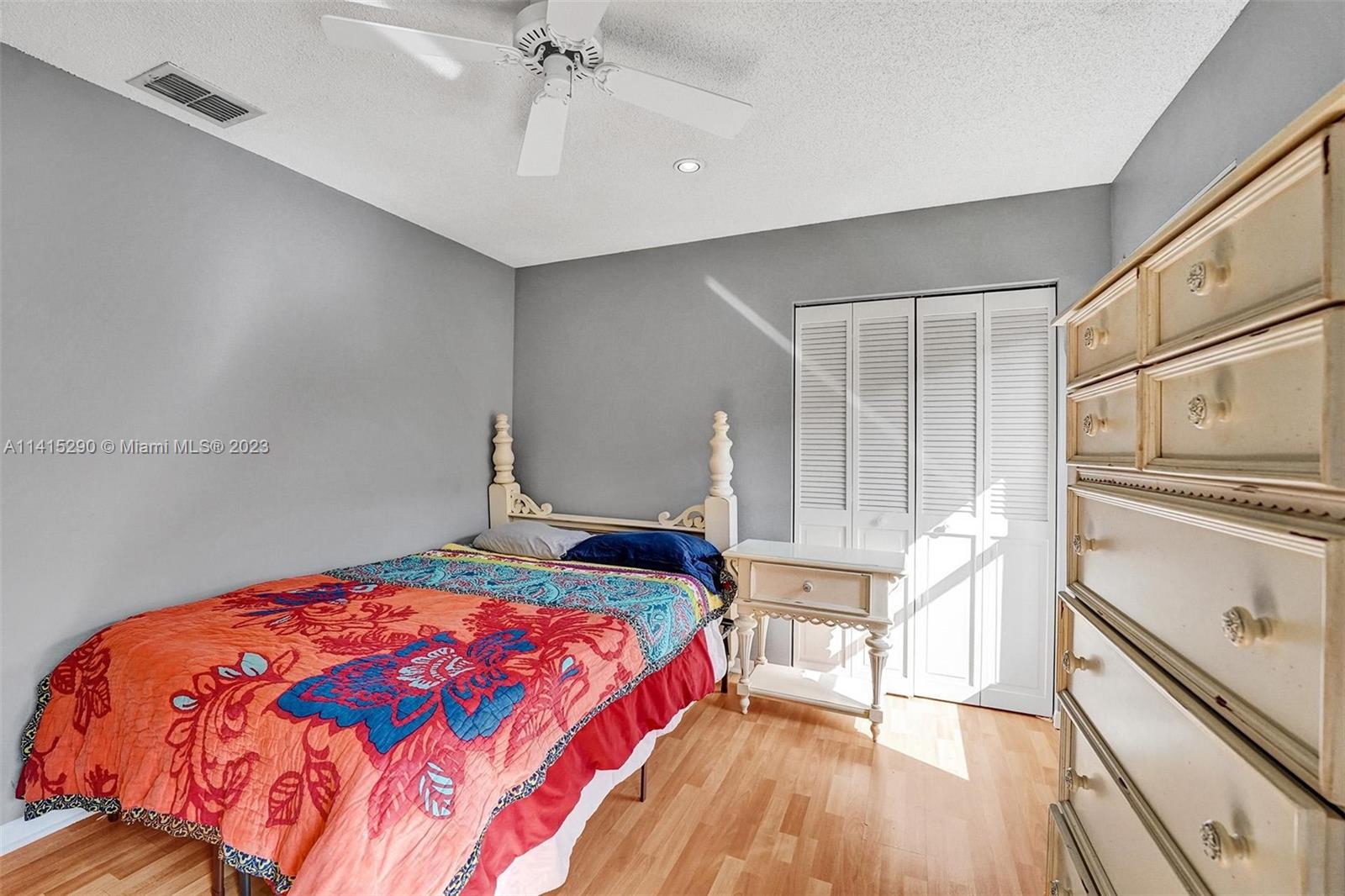 9641 Ridgeside Court Davie, FL 33328 - Photo 58 of 78 a bedroom with a bed and a chandelier