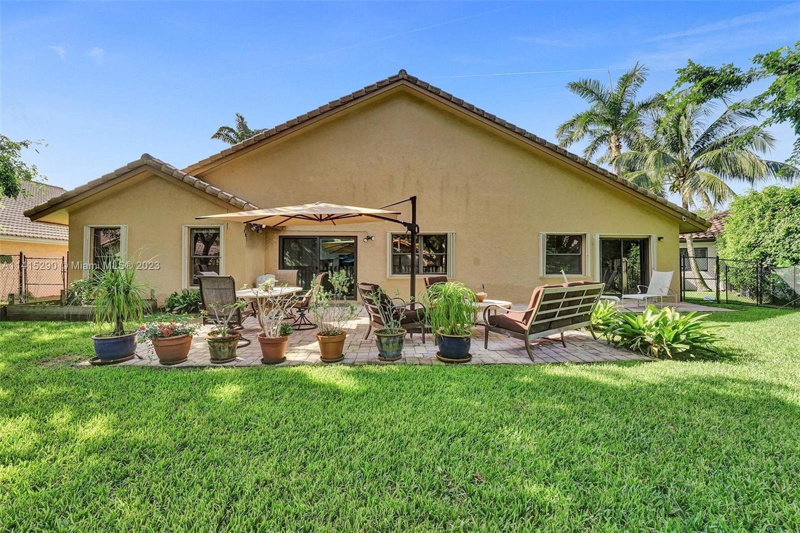 9641 Ridgeside Court Davie, FL 33328 - Photo 64 of 78 a front view of house with yard and outdoor seating