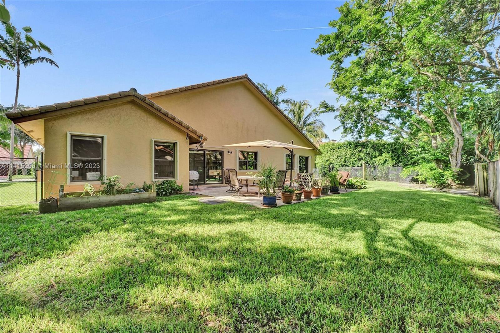 9641 Ridgeside Court Davie, FL 33328 - Photo 66 of 78 a view of a house with backyard