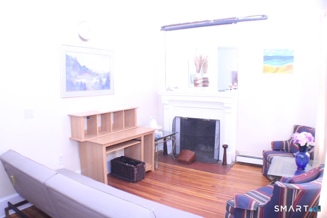 150 Whitney Street Hartford, CT 06105 - Photo 30 of 39 a living room with furniture and a fireplace