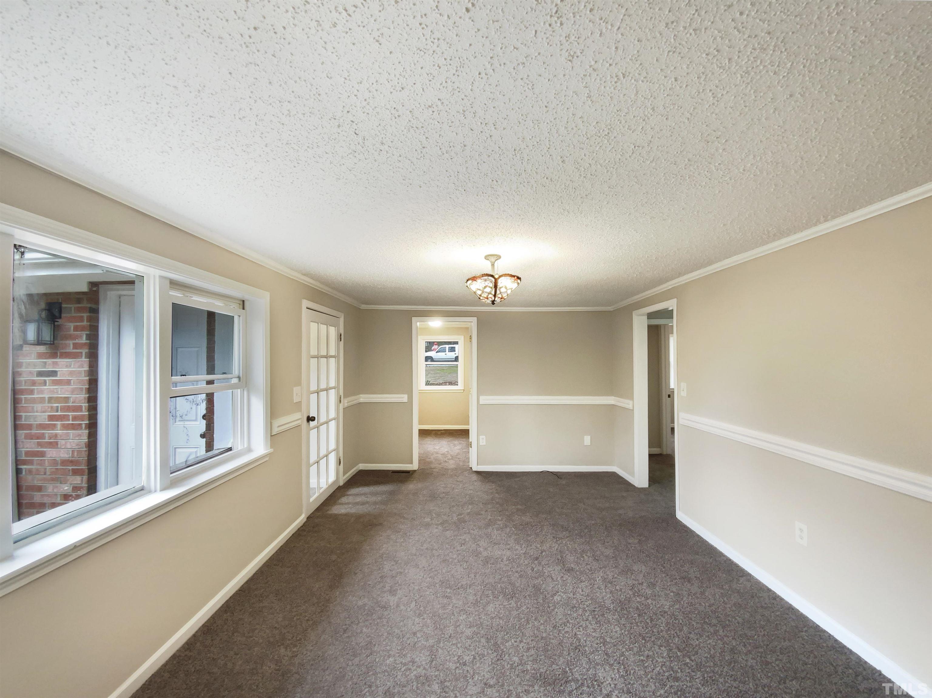 1521 Wiljohn Road Garner, NC 27529 - Photo 13 of 20 an empty room with windows and pillars in it