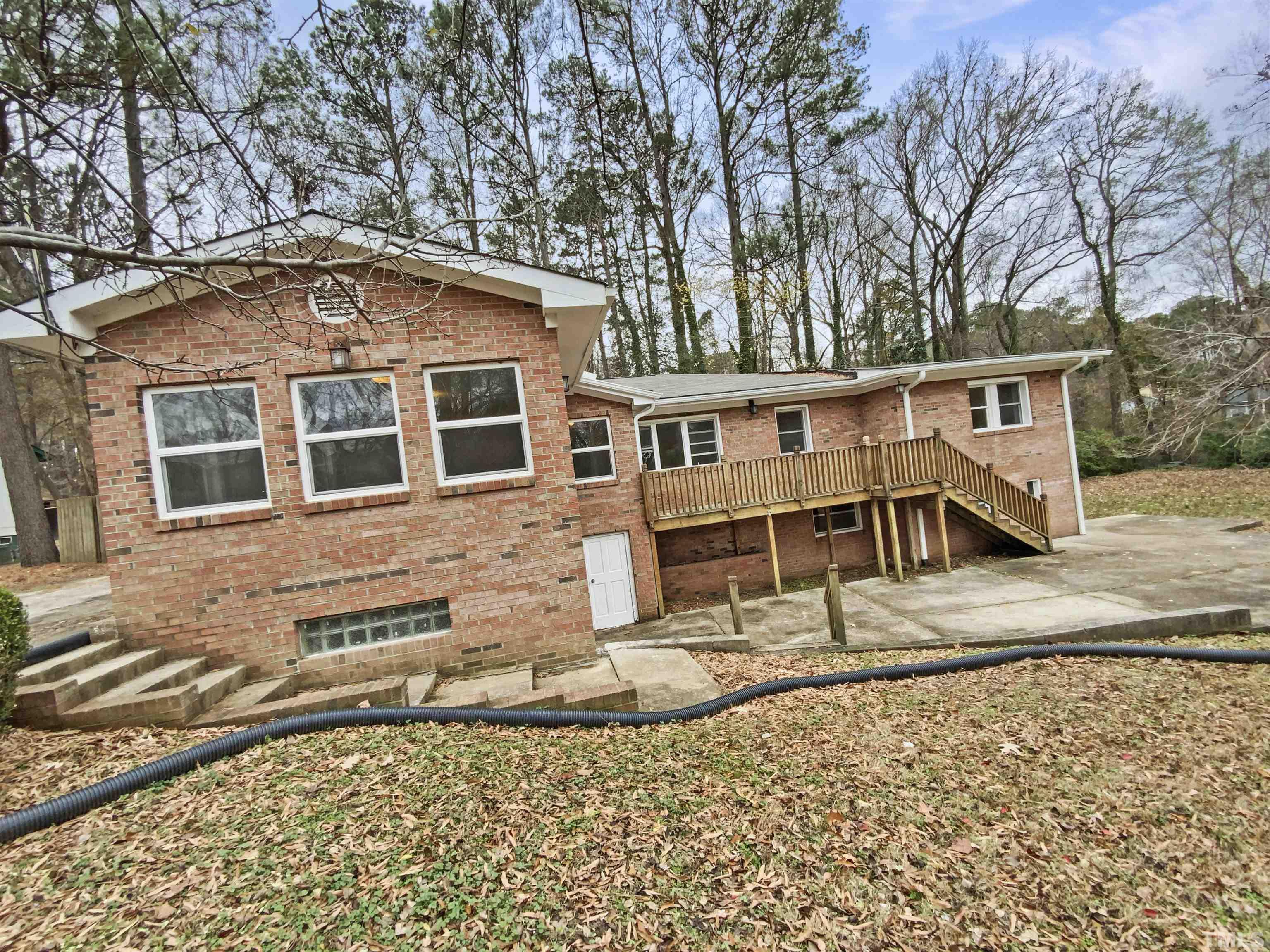 1521 Wiljohn Road Garner, NC 27529 - Photo 20 of 20 front view of a house with a bench