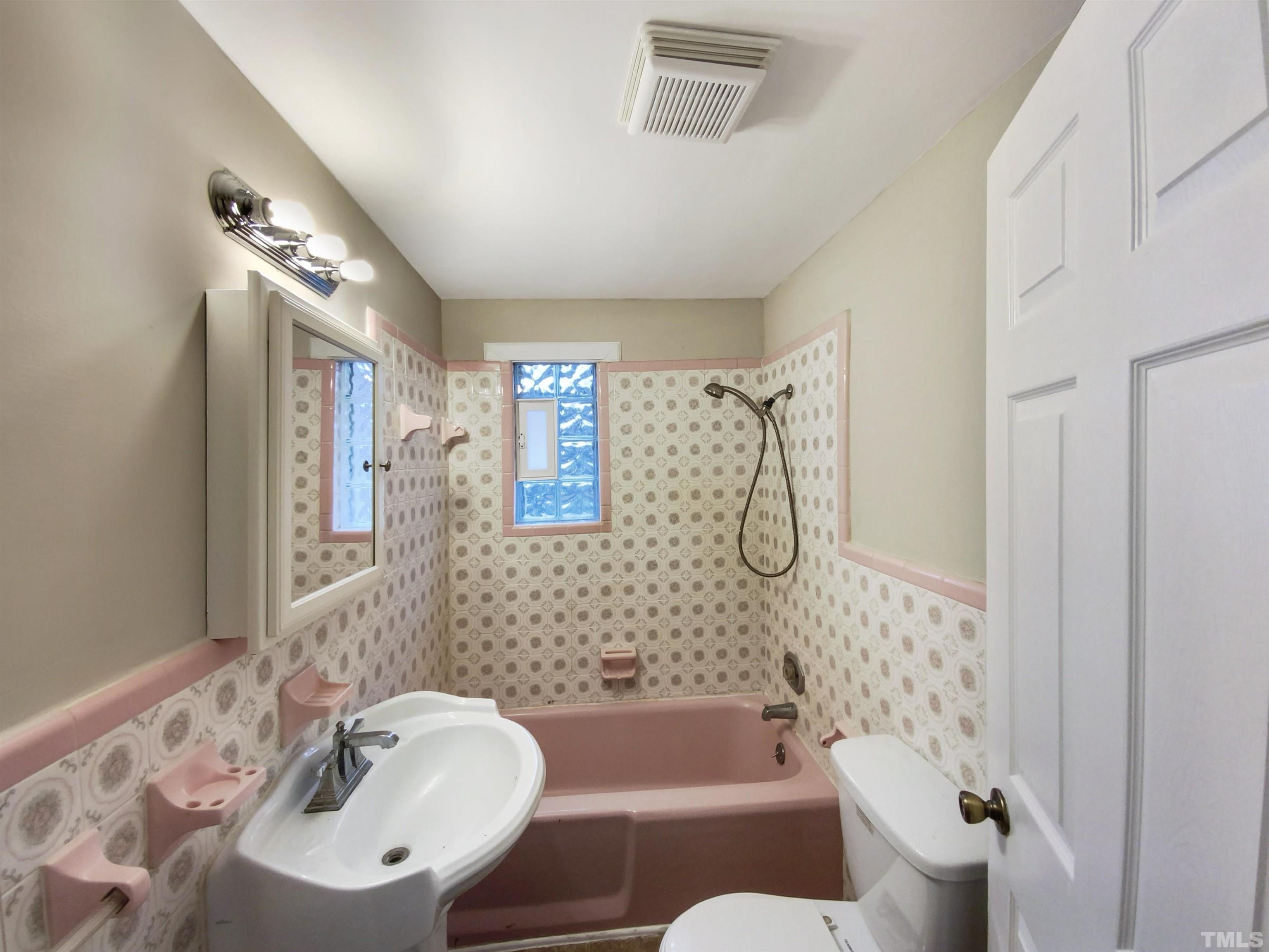 1521 Wiljohn Road Garner, NC 27529 - Photo 6 of 20 a bathroom with a bathtub shower sink mirror and toilet