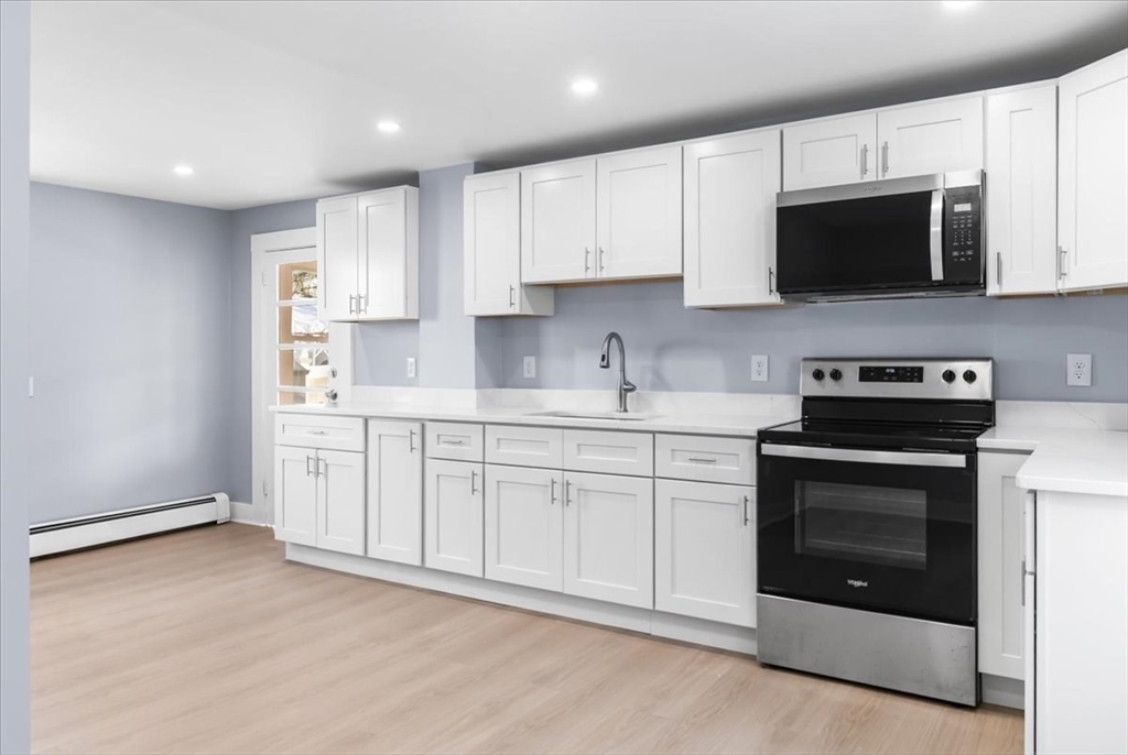 31 Webster Street Winchendon, MA 01475 - Photo 13 of 32 a kitchen with stainless steel appliances granite countertop a sink a stove a microwave and cabinets
