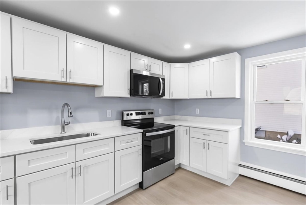 31 Webster Street Winchendon, MA 01475 - Photo 14 of 32 a kitchen with white cabinets stainless steel appliances and a sink