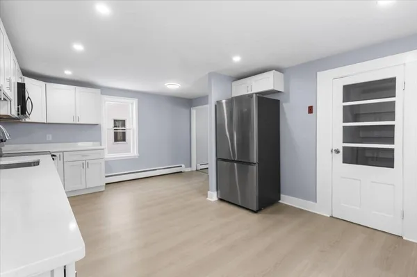 a kitchen with stainless steel appliances a refrigerator and a stove top oven