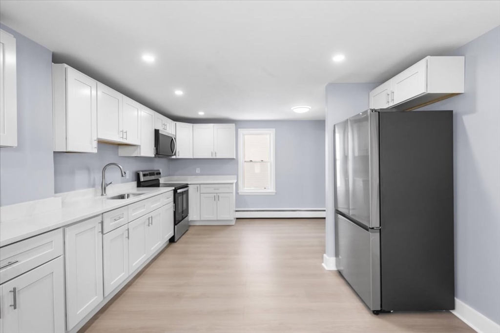 31 Webster Street Winchendon, MA 01475 - Photo 17 of 32 a kitchen with white cabinets and white appliances