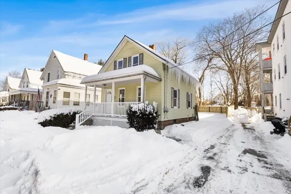 a view of a covered with snow in front of house