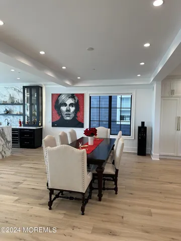 a kitchen with kitchen island granite countertop a sink and a stove top oven