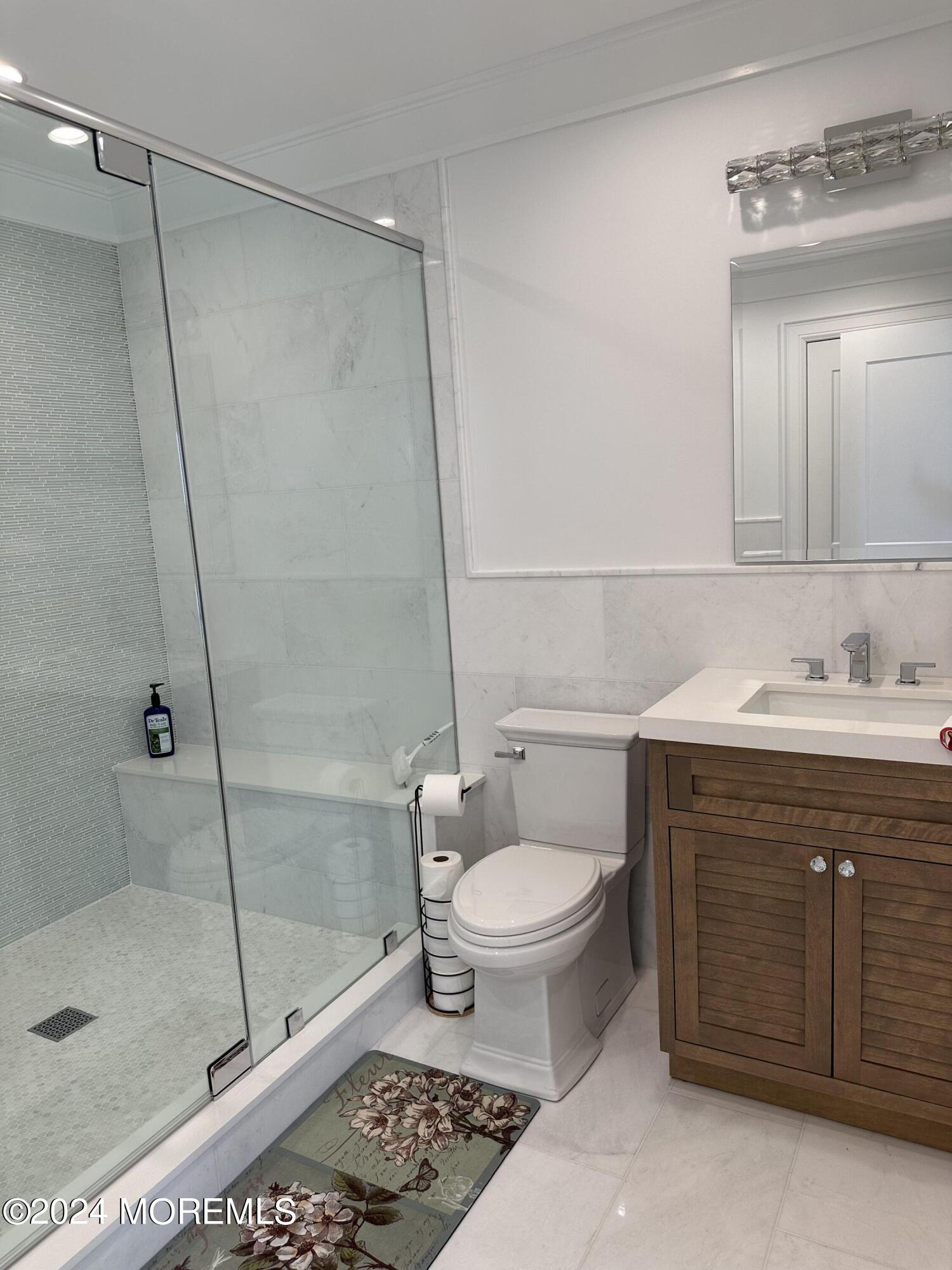 13 Ocean Terrace Long Branch, NJ 07740 - Photo 16 of 49 a bathroom with a sink toilet a mirror and shower