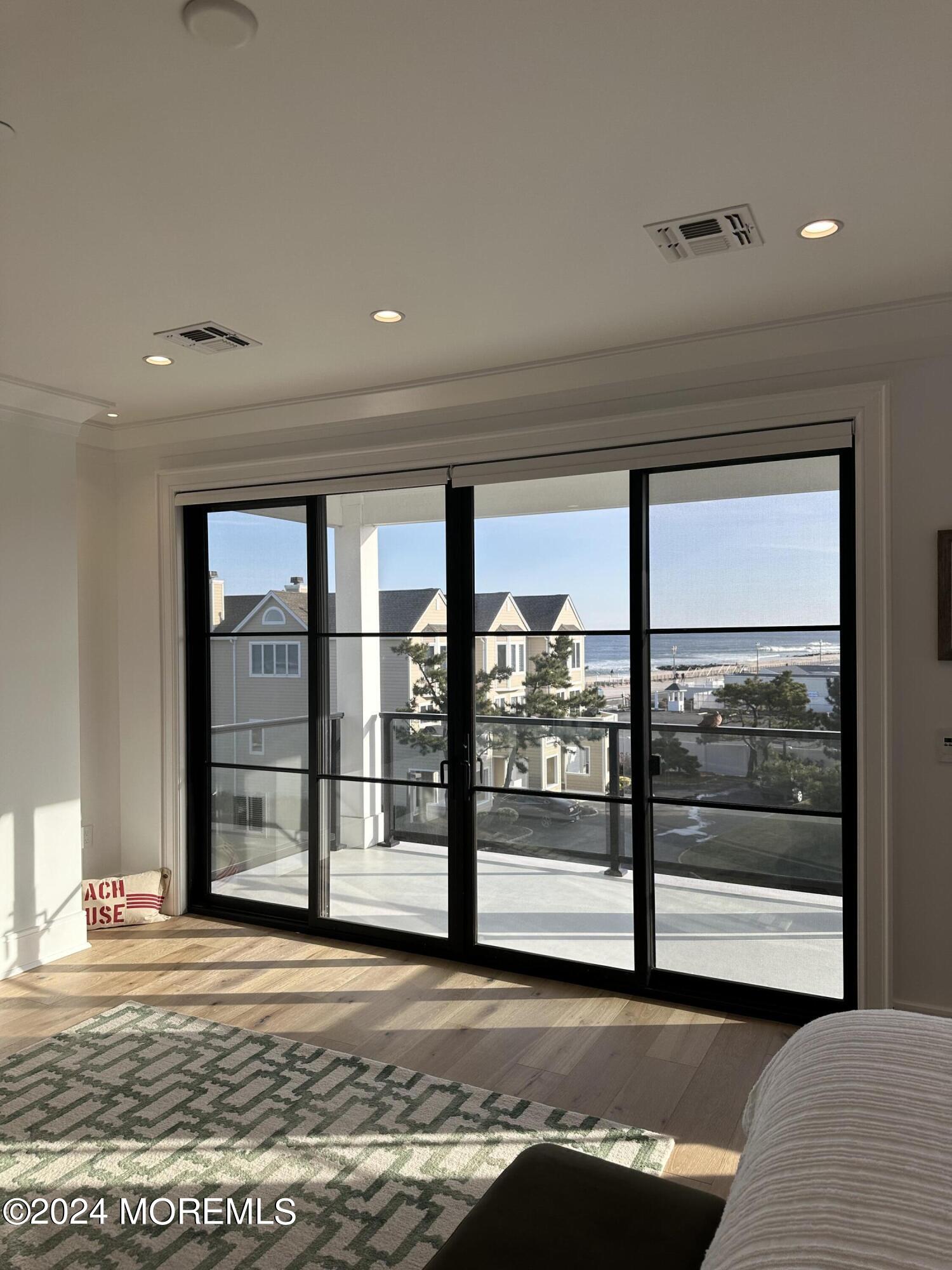 13 Ocean Terrace Long Branch, NJ 07740 - Photo 24 of 49 a view of an empty room with wooden floor and a window