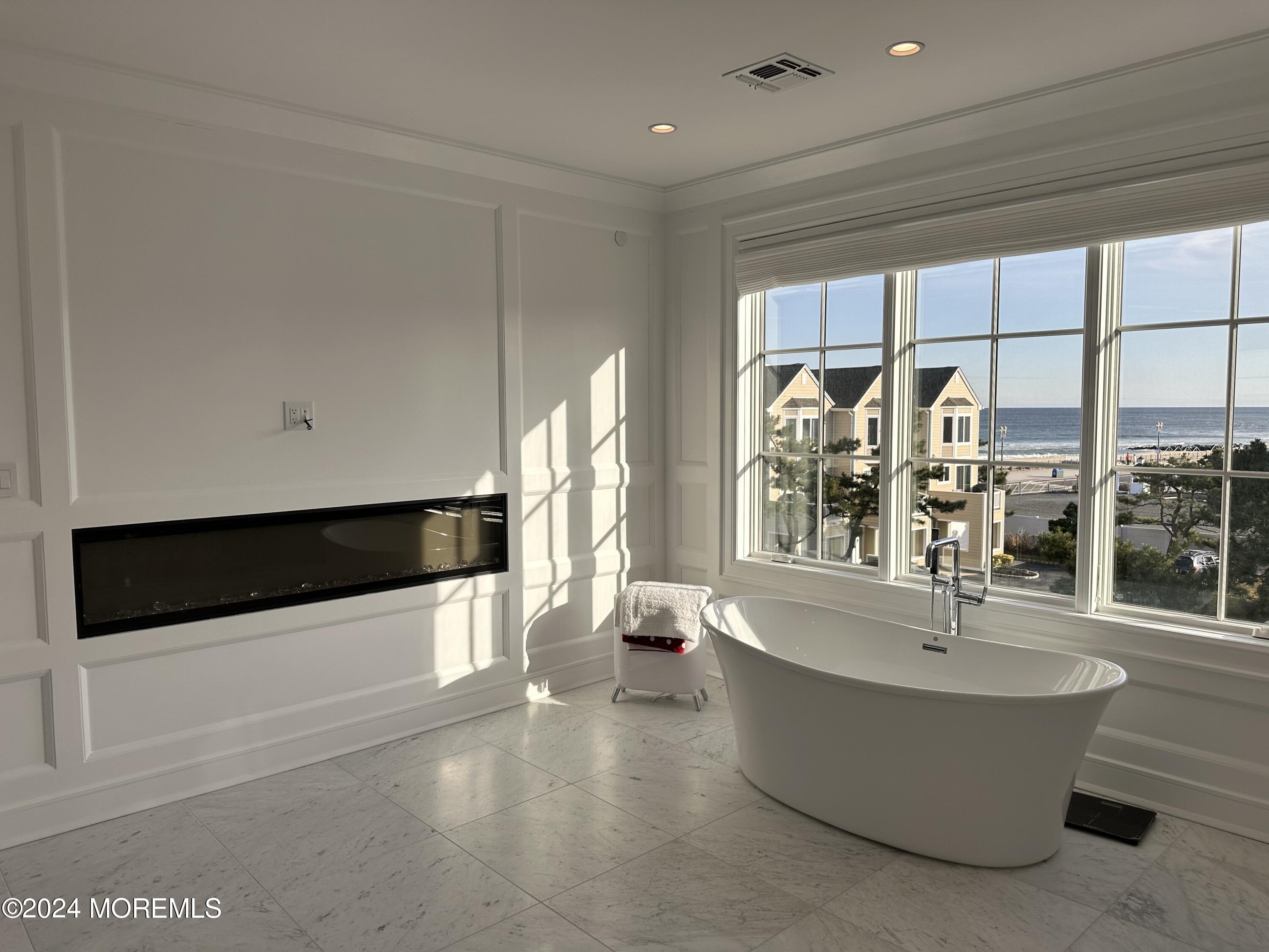 13 Ocean Terrace Long Branch, NJ 07740 - Photo 31 of 49 a living room with large windows and a table