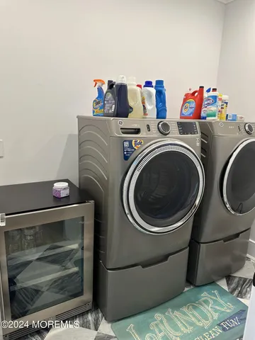 a living room with furniture large windows and flat screen tv
