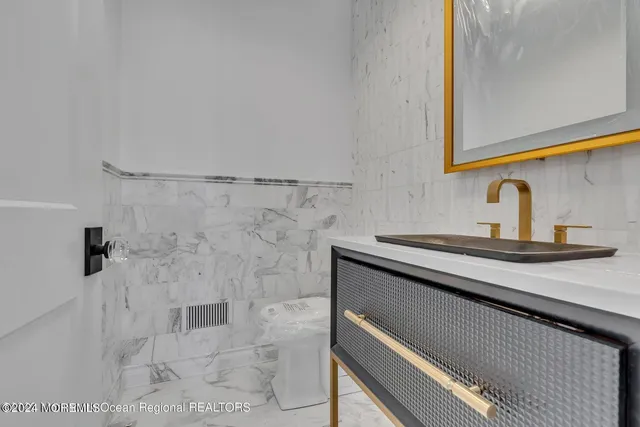 a open kitchen with lots of wooden furniture a dining table and chairs