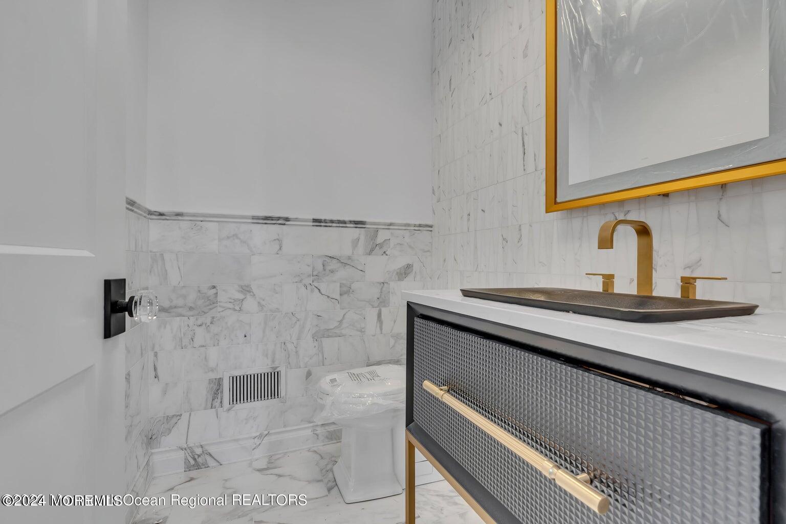 13 Ocean Terrace Long Branch, NJ 07740 - Photo 7 of 49 a bathroom with a sink and a mirror