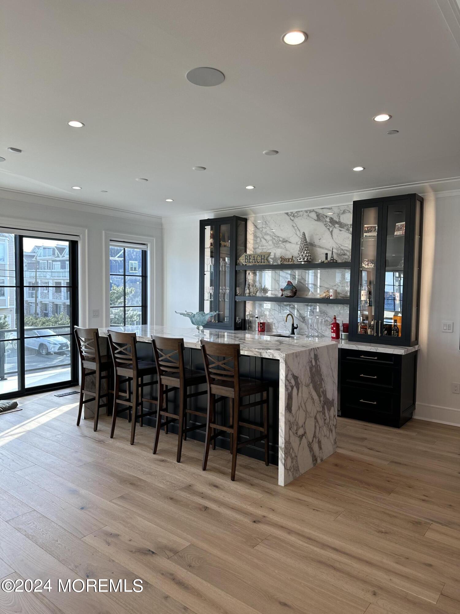13 Ocean Terrace Long Branch, NJ 07740 - Photo 8 of 49 a open kitchen with lots of wooden furniture a dining table and chairs
