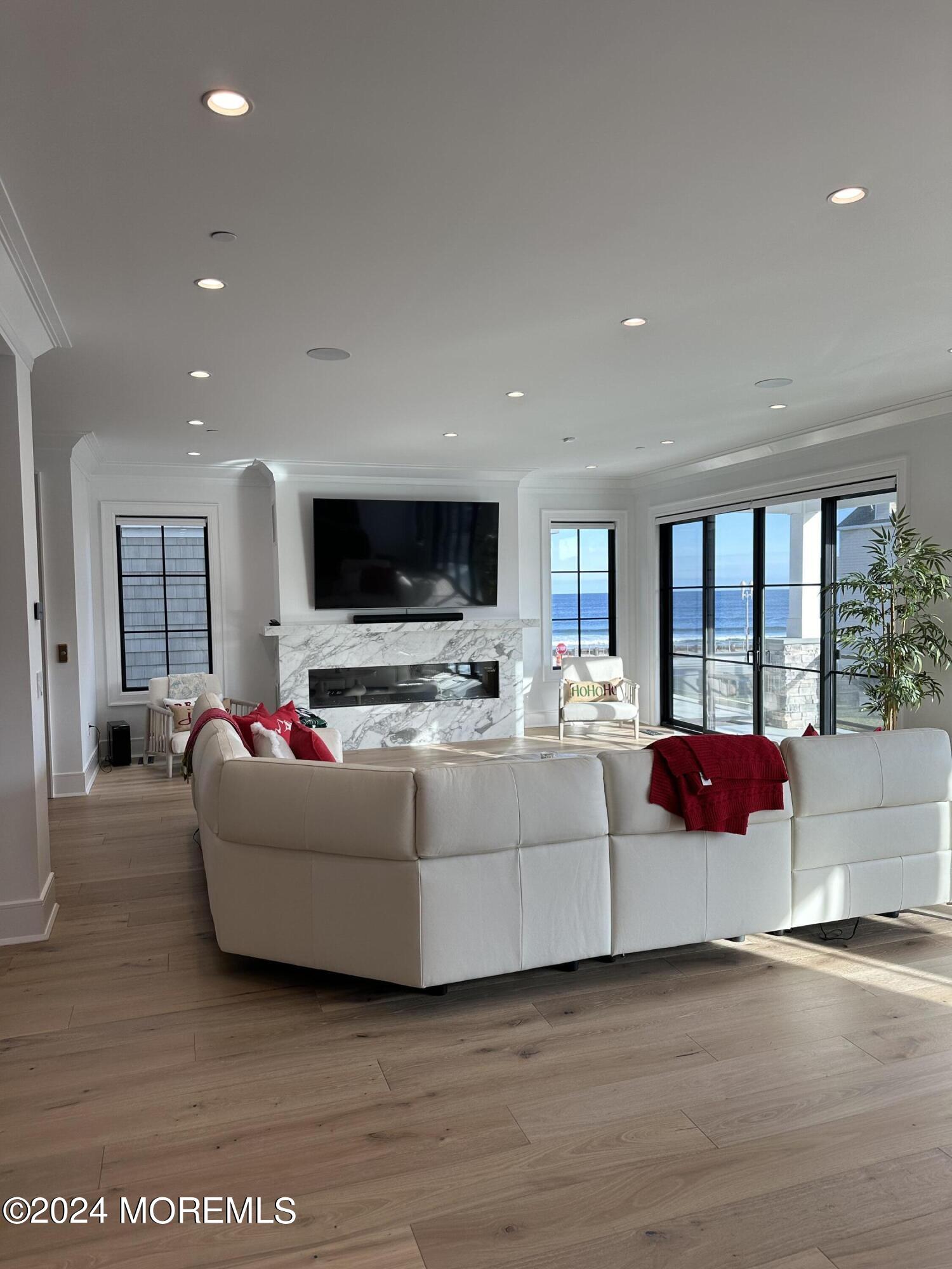 13 Ocean Terrace Long Branch, NJ 07740 - Photo 9 of 49 a living room with furniture fireplace and flat screen tv