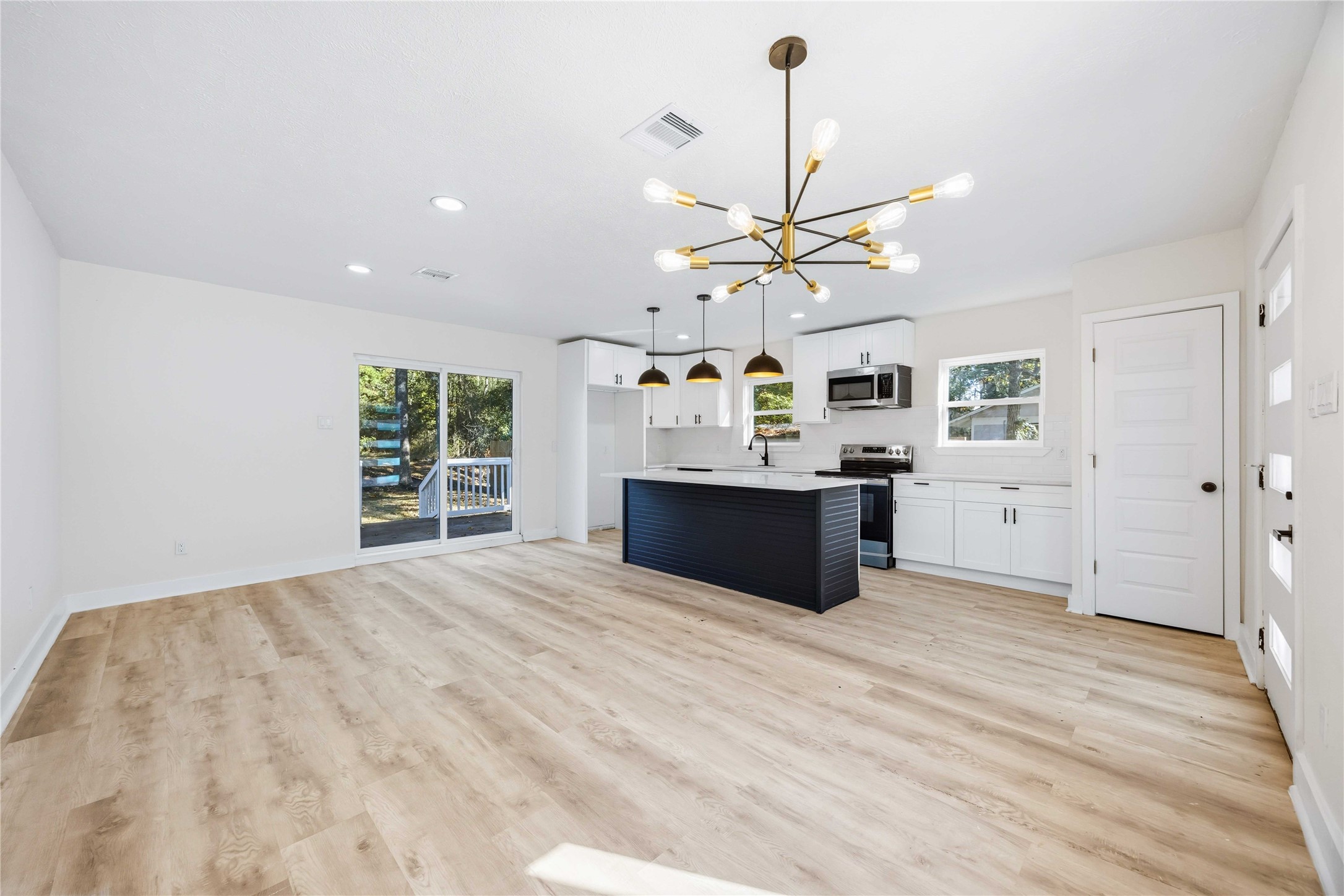 18234 Atkinson Lane Conroe, TX 77384 - Photo 8 of 30 a large kitchen with stainless steel appliances a large window