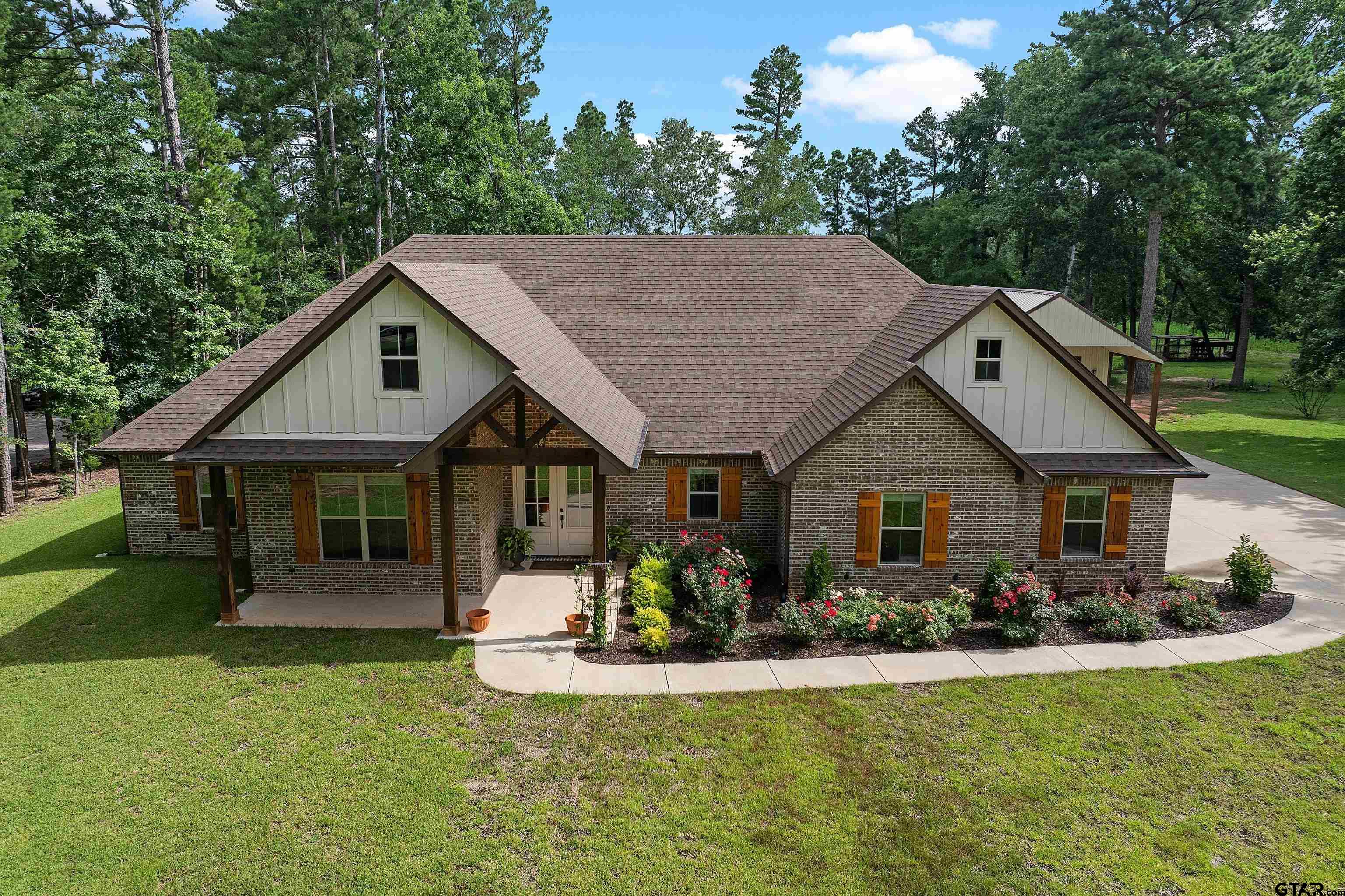 434 King Ranch Road Kilgore, TX 75662 - Photo 11 of 34 a front view of house with a garden and patio