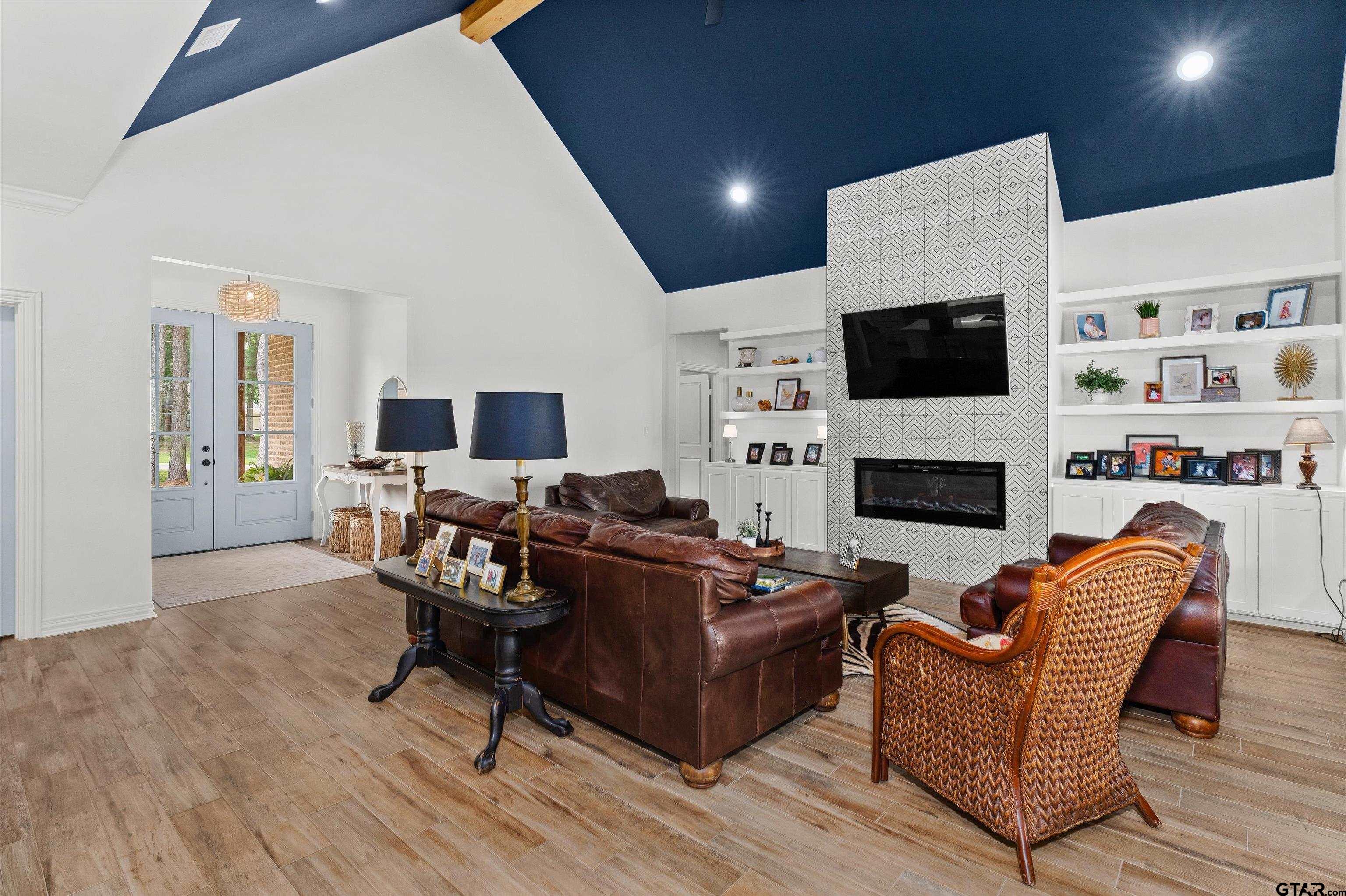 434 King Ranch Road Kilgore, TX 75662 - Photo 15 of 34 a living room with furniture a flat screen tv and a fireplace