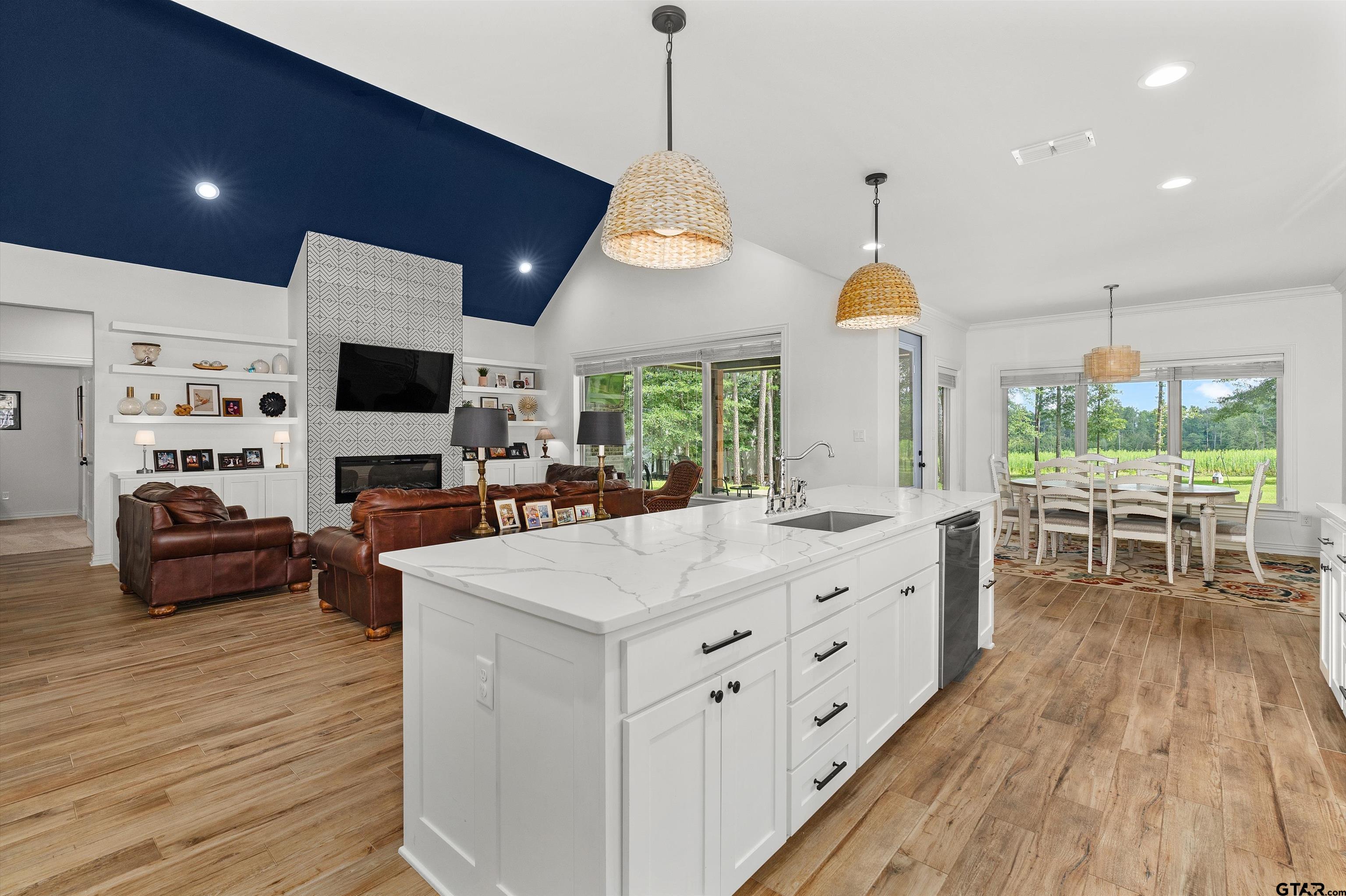 434 King Ranch Road Kilgore, TX 75662 - Photo 20 of 34 a kitchen with stainless steel appliances kitchen island granite countertop a stove a sink a dining table and chairs with wooden floor