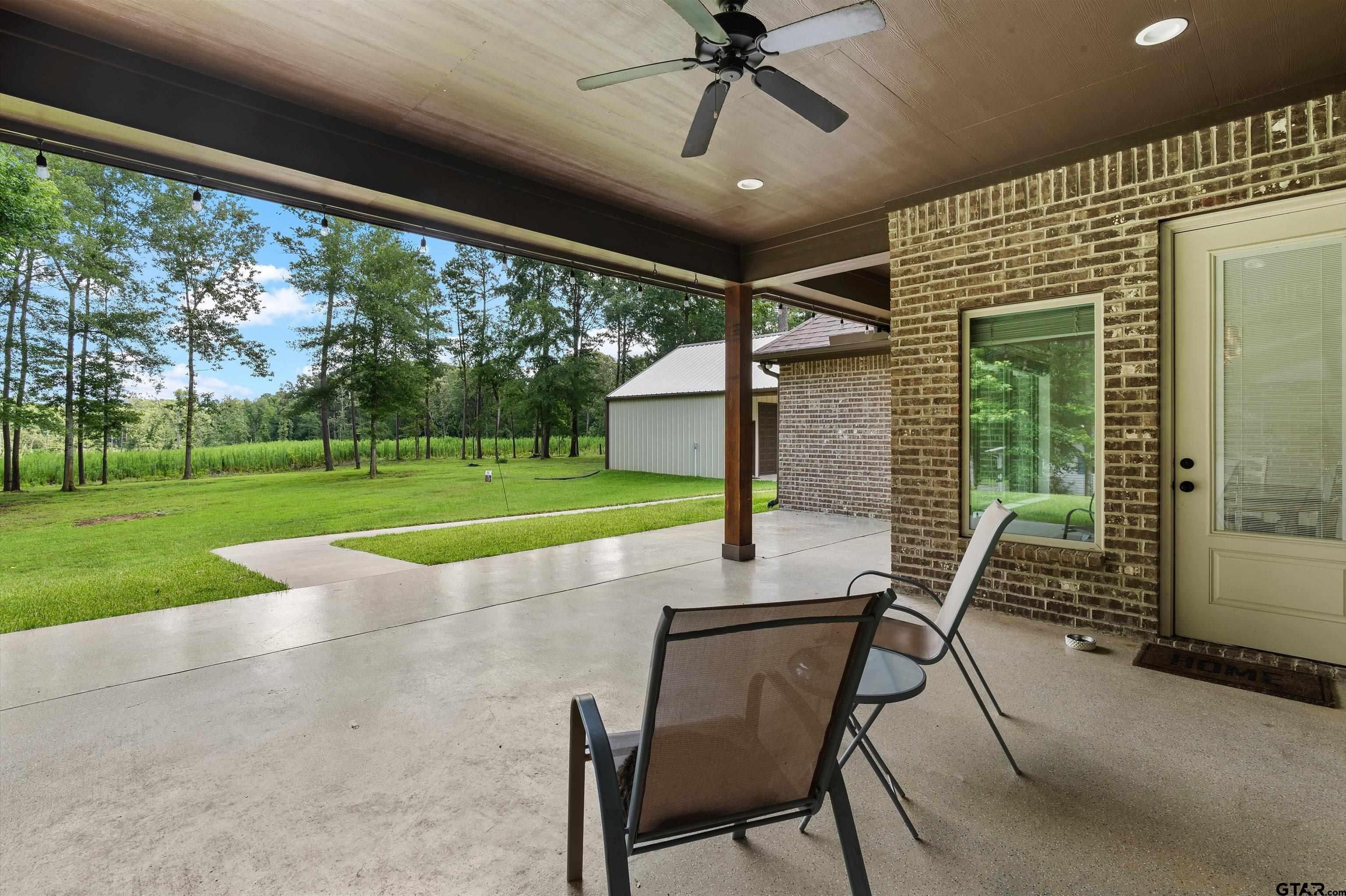434 King Ranch Road Kilgore, TX 75662 - Photo 2 of 34 a view of a porch with a table chairs and backyard