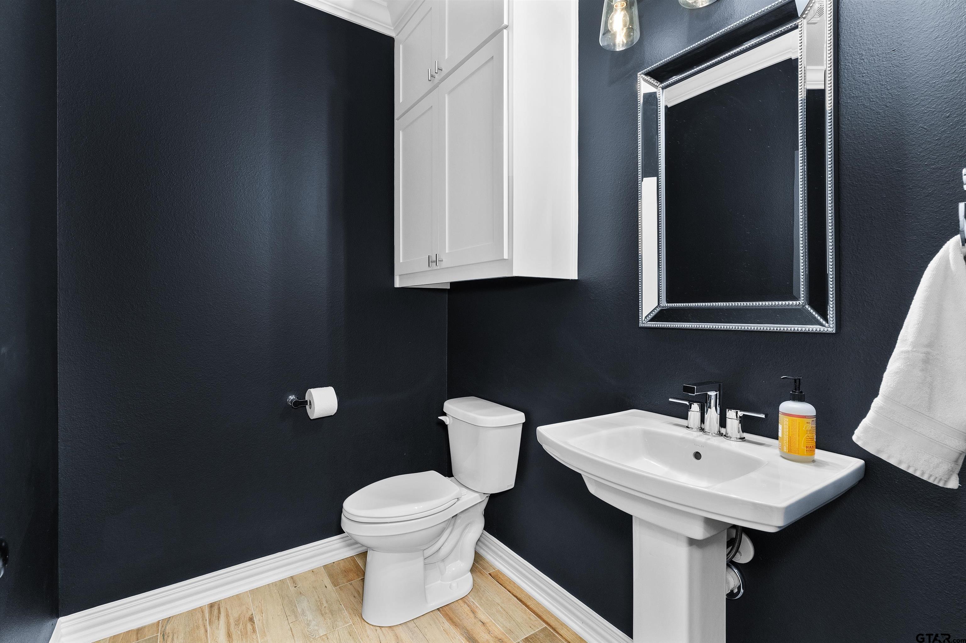 434 King Ranch Road Kilgore, TX 75662 - Photo 34 of 34 a bathroom with a sink a toilet and mirror