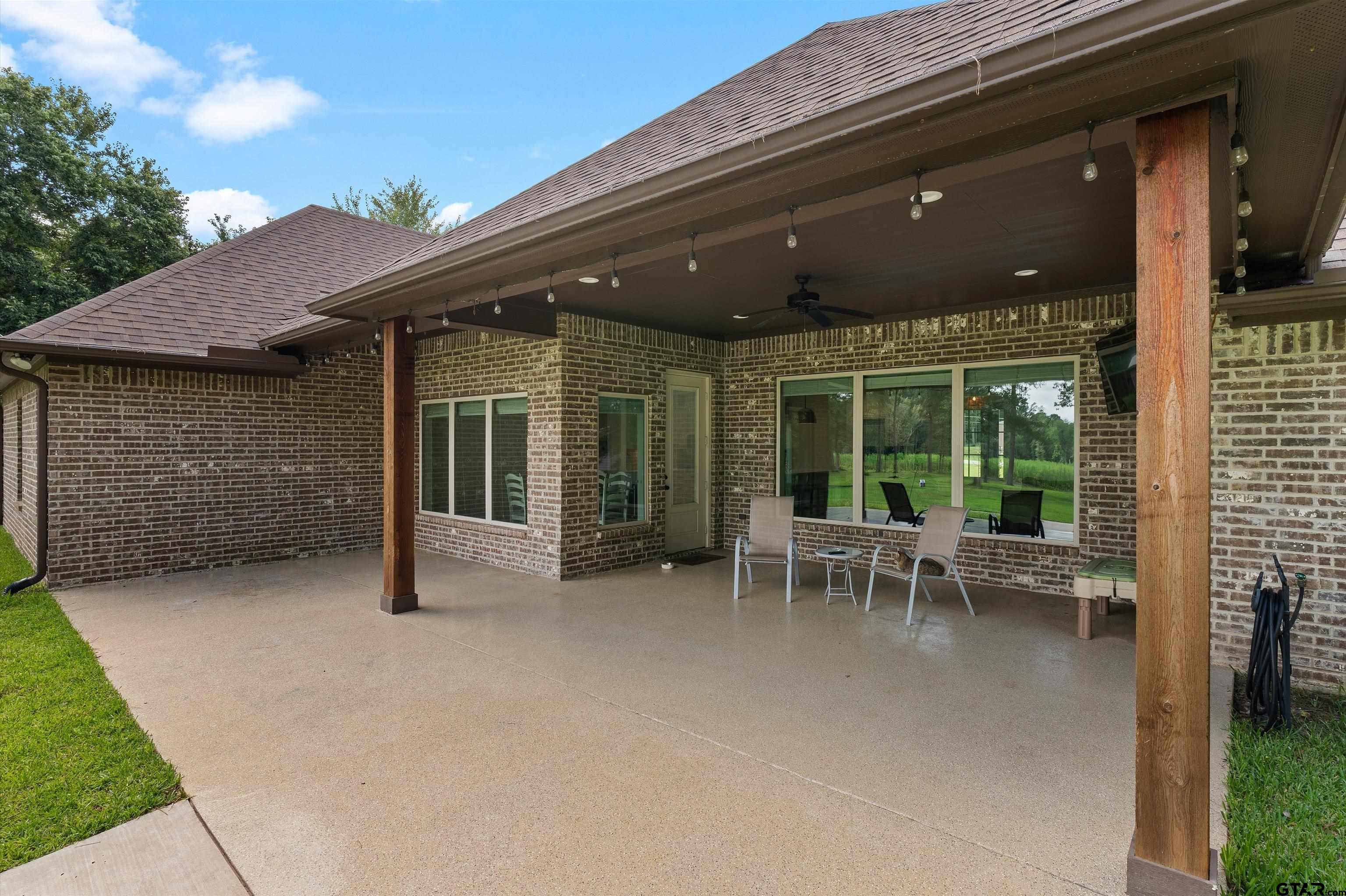 434 King Ranch Road Kilgore, TX 75662 - Photo 5 of 34 a view of a patio with table and chairs and floor to ceiling window