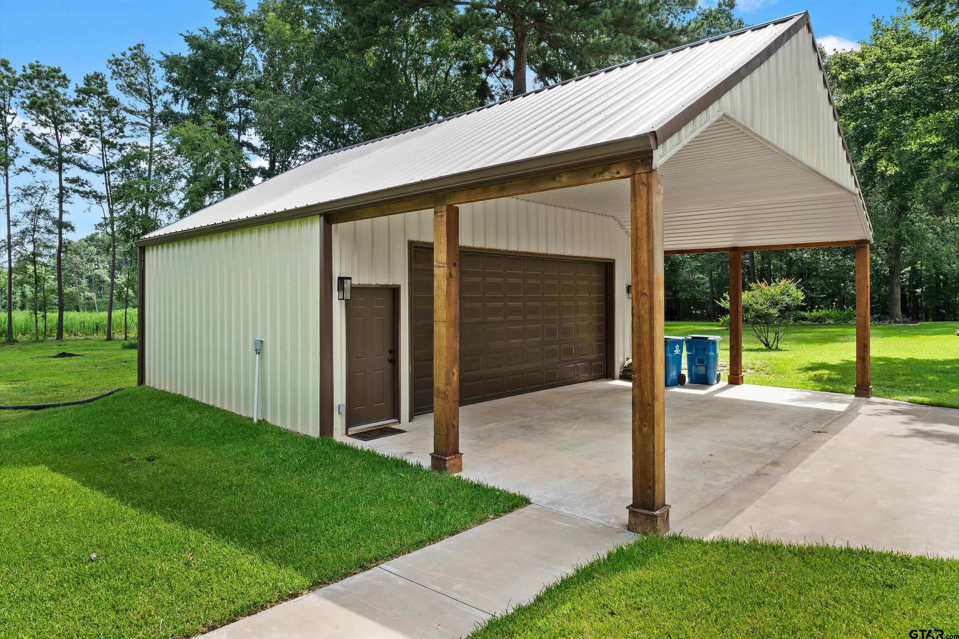 434 King Ranch Road Kilgore, TX 75662 - Photo 10 of 34 a view of a house with a yard and garage