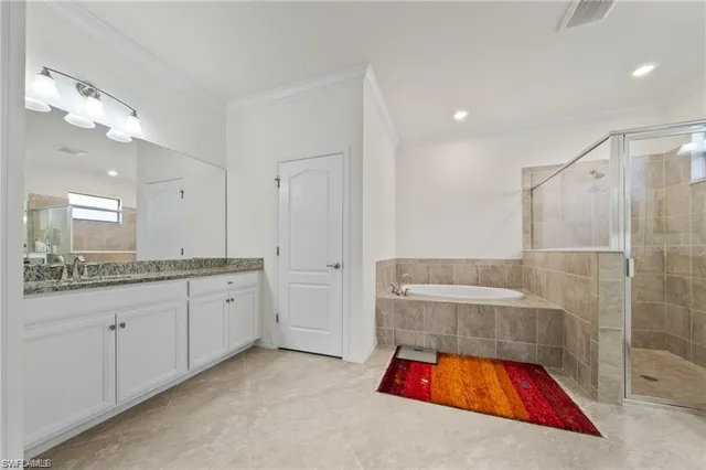 a bathroom with a tub a sink and mirrors