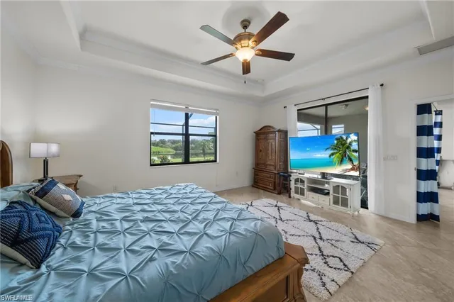 a bedroom with a bed and a large window with the outer view