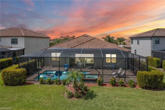 a backyard of a house with table and chairs