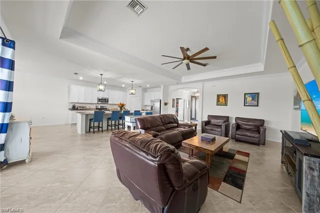 a living room with furniture and kitchen view