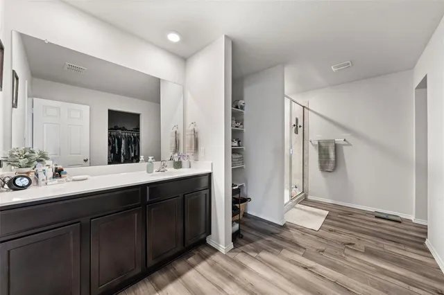 a bed room with a bed and a chair