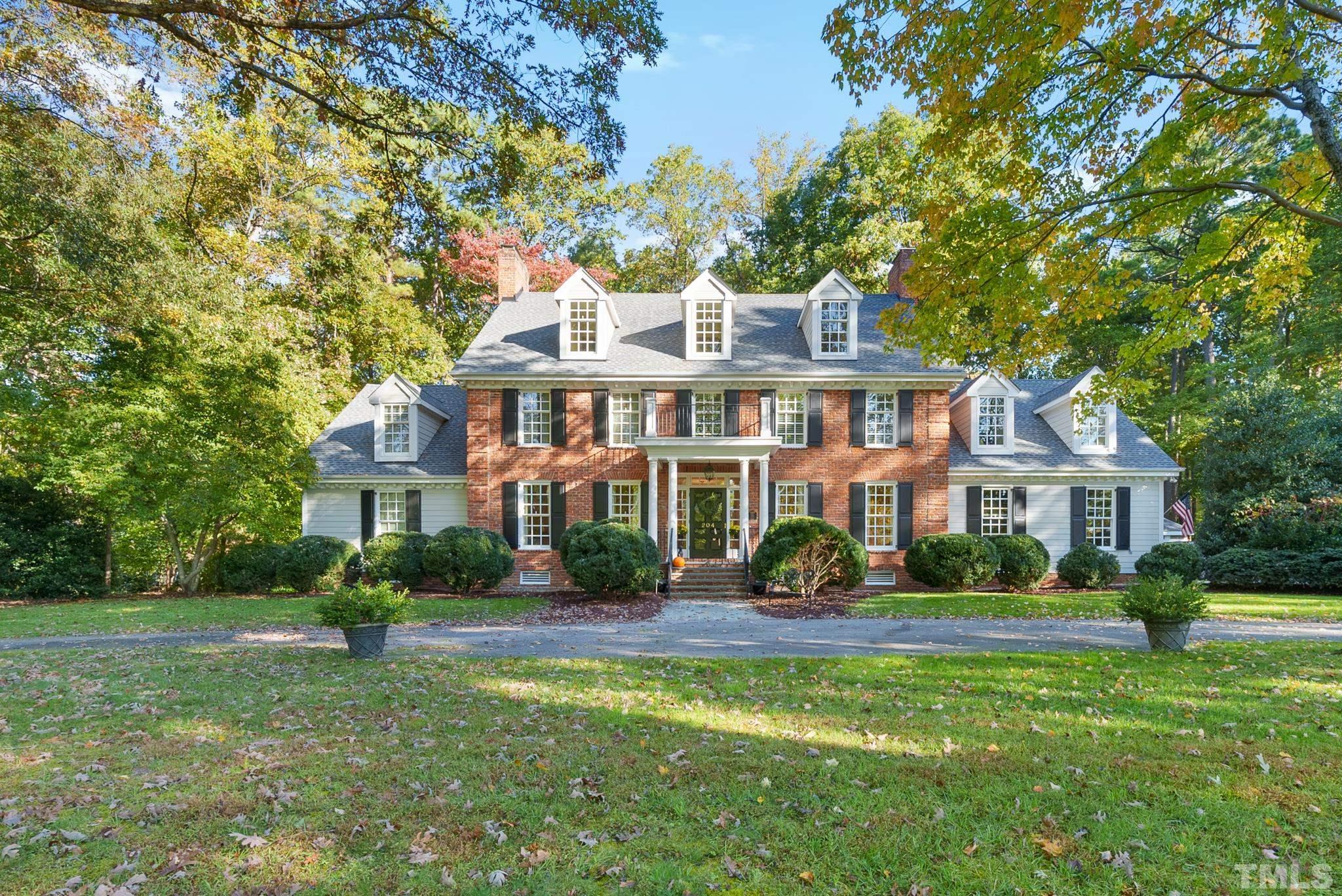 204 Queensferry Road Cary, NC 27511 - Photo 1 of 41 a front view of a house with a garden